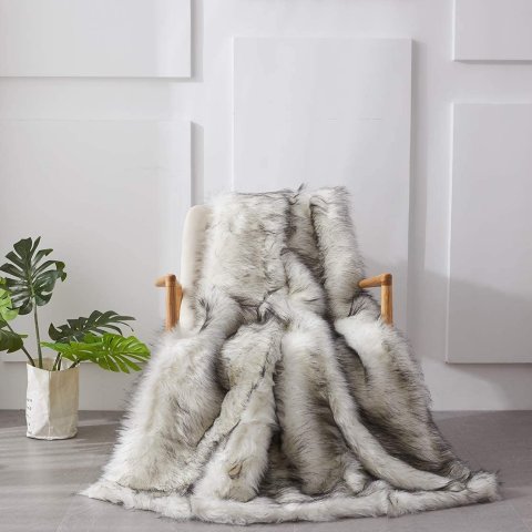 White faux fur throw draped over a wooden armchair