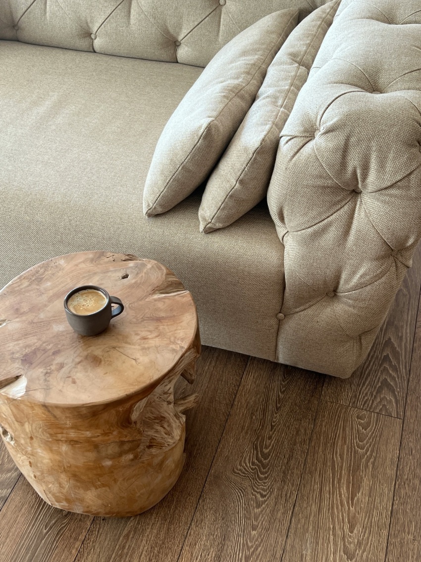 A calm, naturally designed living room with organic forms and soft light