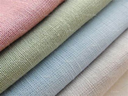 Stack of draped pastel linen fabric swatches
