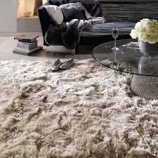 Thick shaggy cream rug beside a glass coffee table