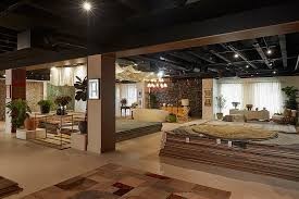 Open-plan showroom using rugs to zone different seating areas